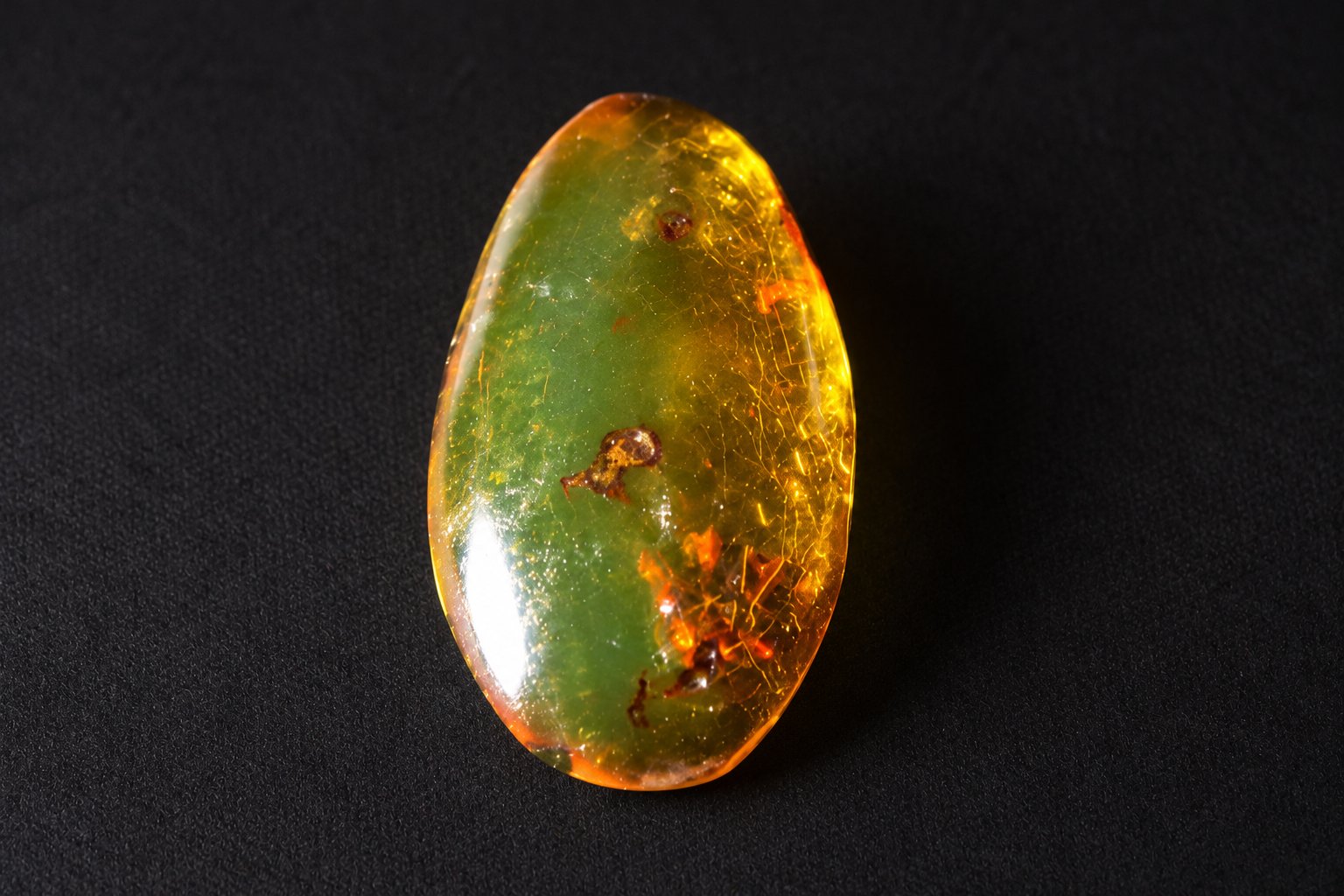 Authentic deep green Dominican amber cabochon